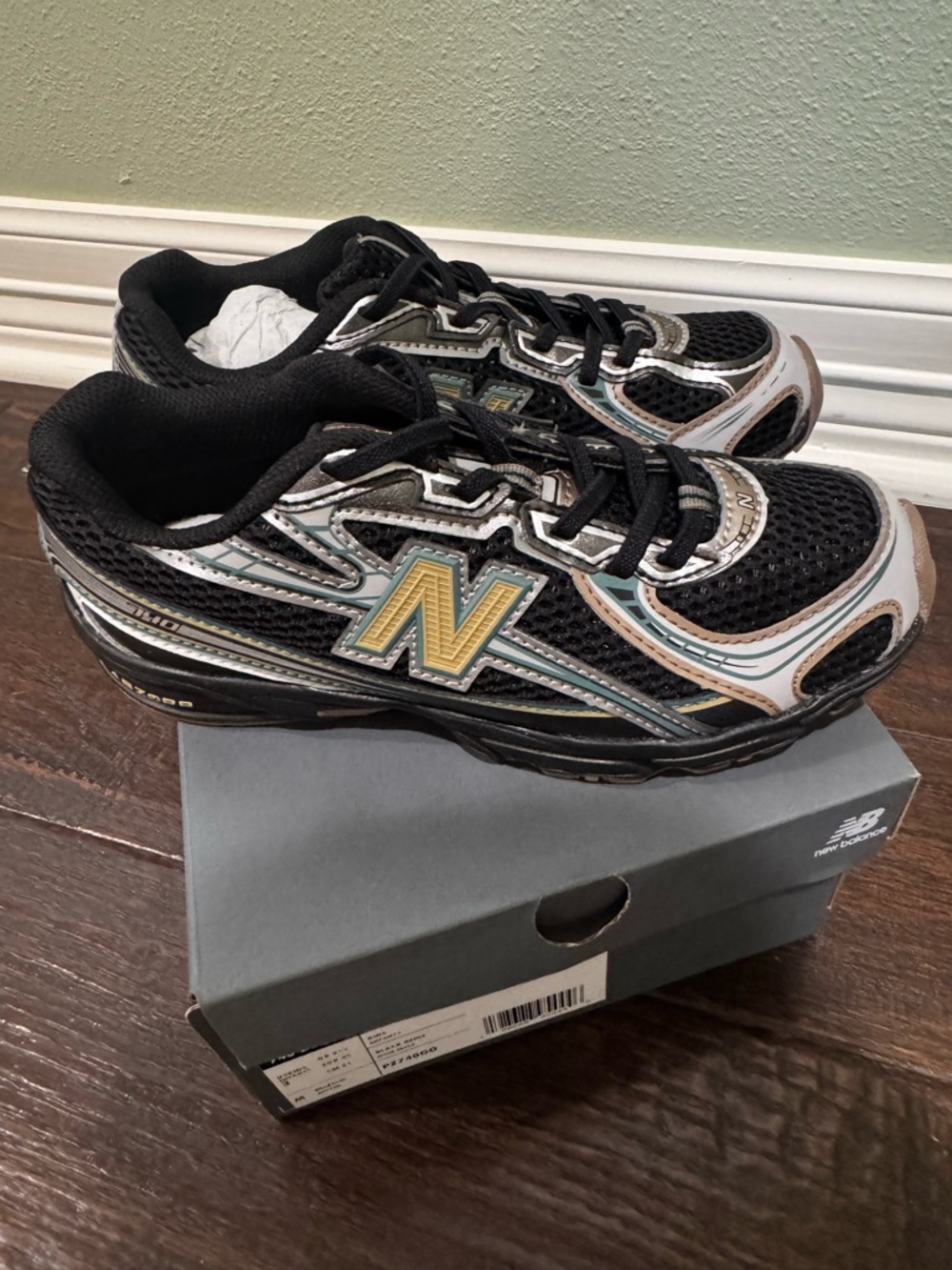New Balance Kids Black Sneakers with Gold 'N' Accent